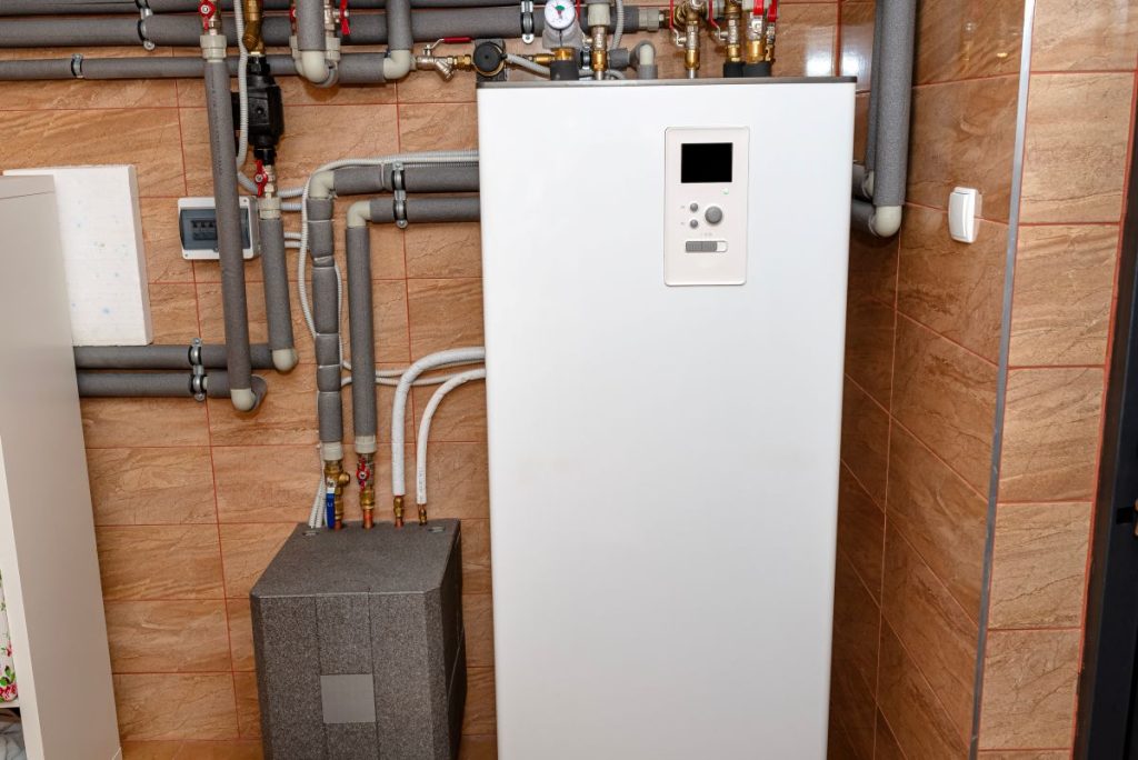 boiler room, visible plastic pipes and valves.